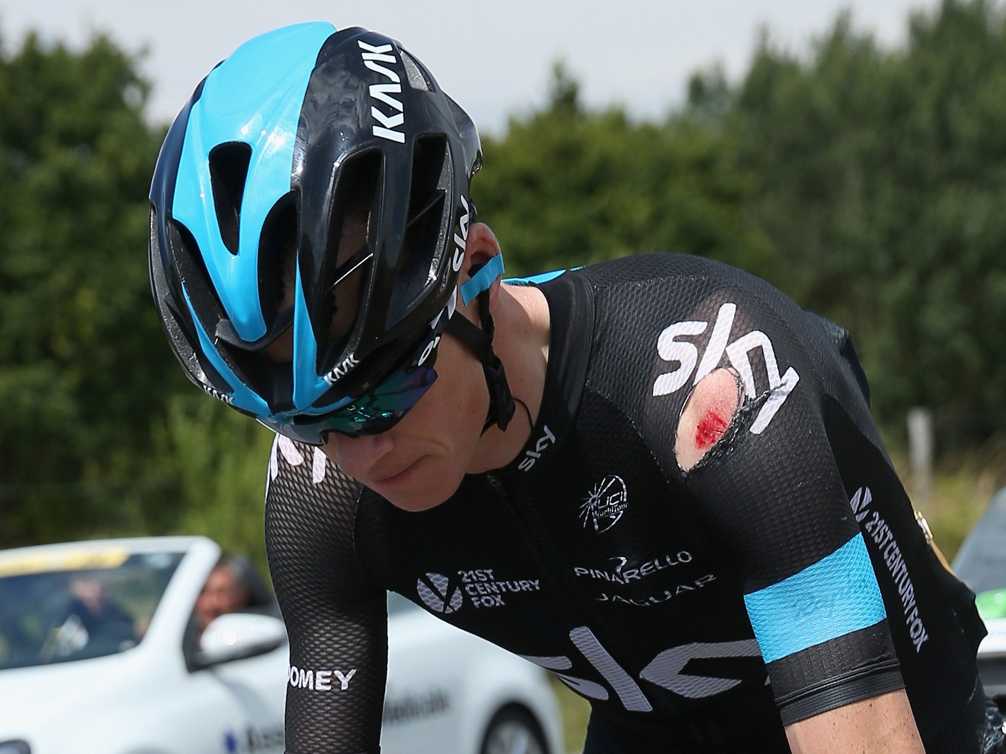 Chris Froome of Great Britain and Team Sky chases back to the peloton after being involved in a crash just after the start of stage four