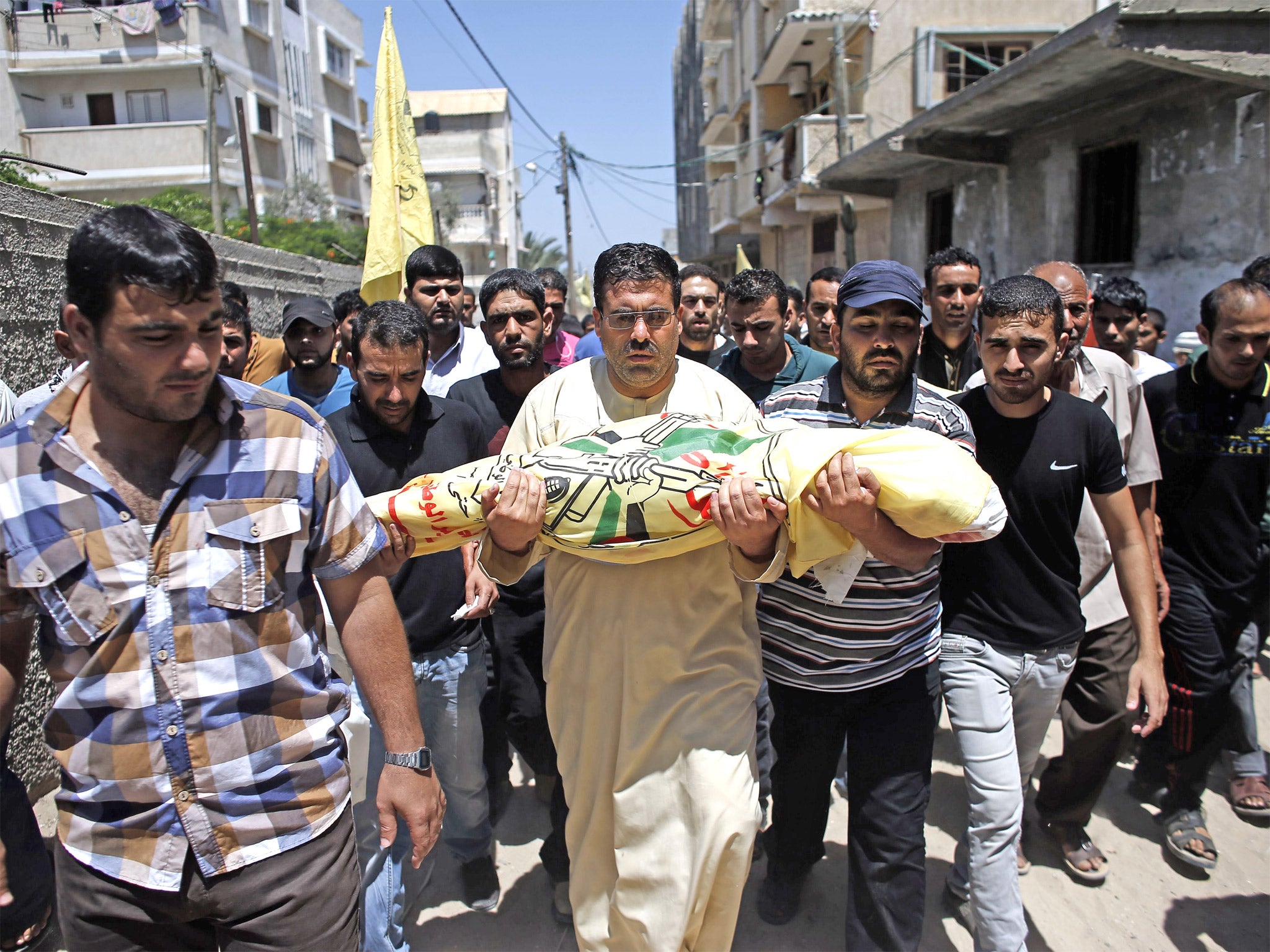 Relatives and friends of the al-Kaware family carry one of the seven members of the family to the mosque during their funeral in Khan Yunis. The father and his six sons were all killed in an Israeli air strike