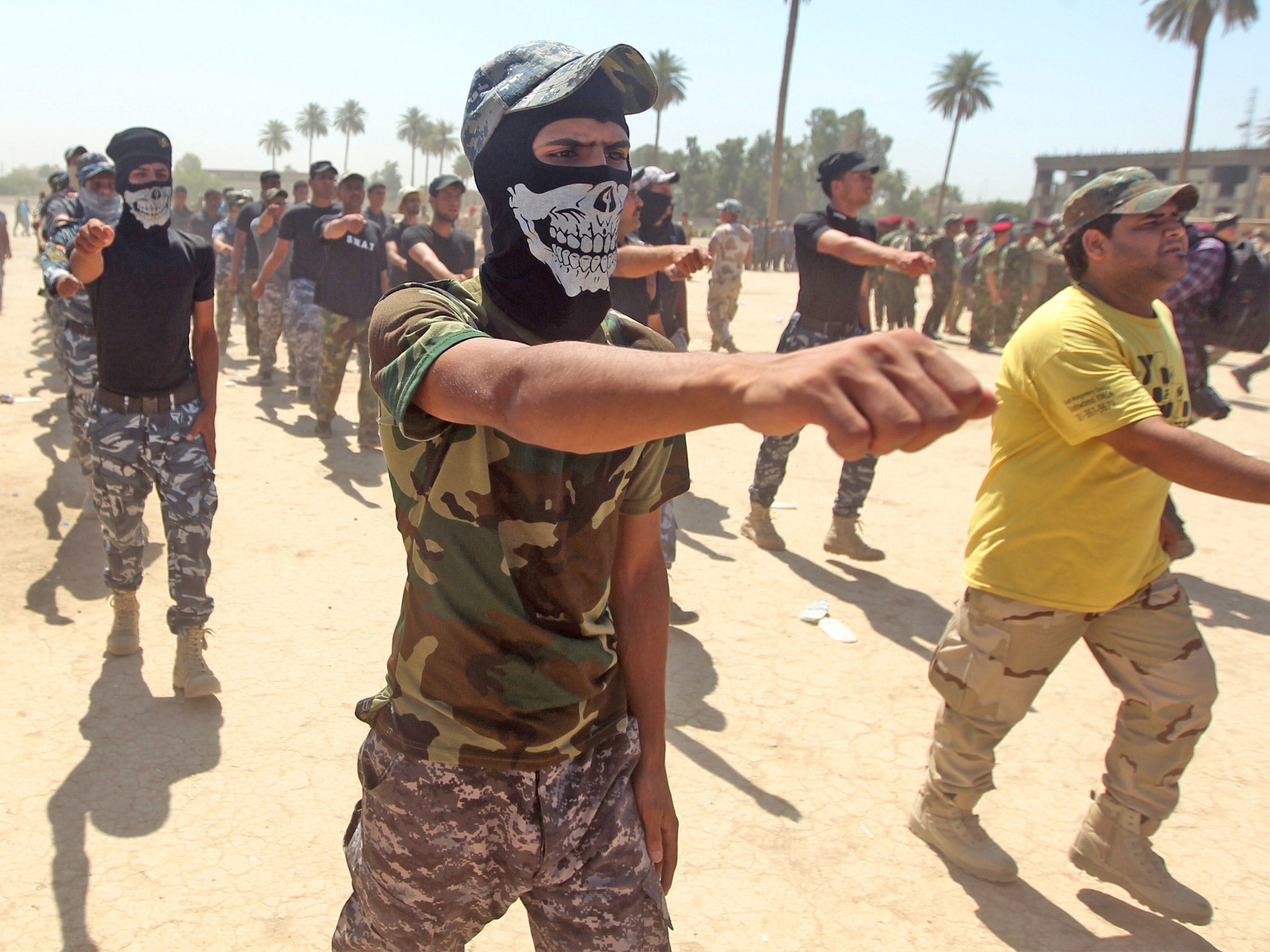 Shia recruits from the Iraqi Hezbollah brigade march in Baghdad to join the national army in its fight against Isis (Getty)