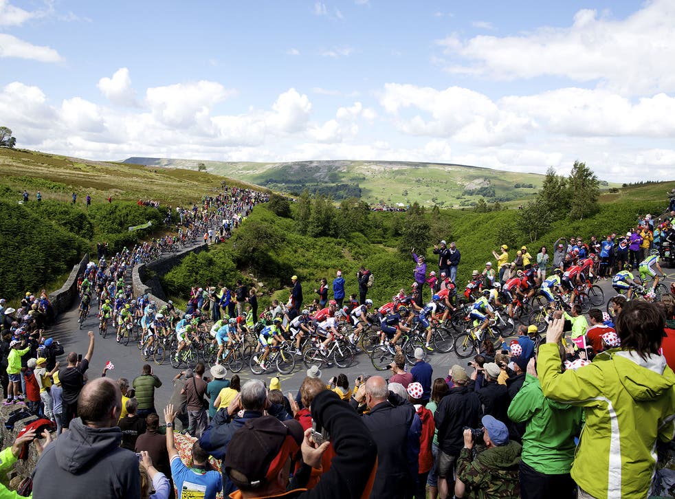 Spectators photograph the Tour de France riders as they make their way through the Yorkshire countryside