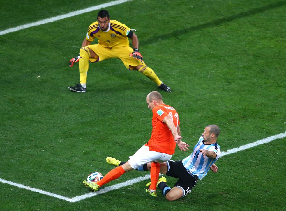 Javier Mascherano of Argentina tackles Arjen Robben of the Netherlands as he attempts a shot 
