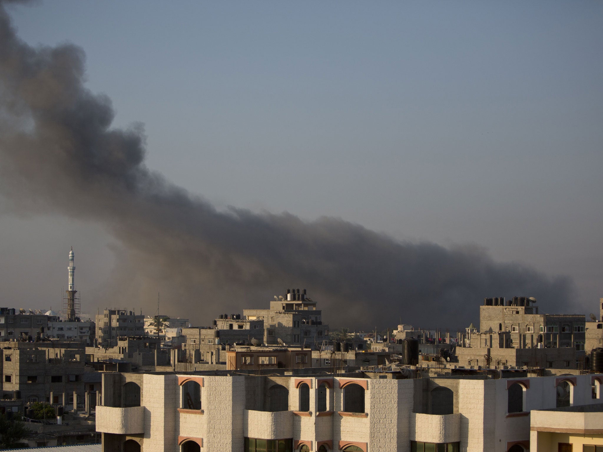 Smoke billows from buildings following an Israeli air strike in Gaza on July 10, 2014