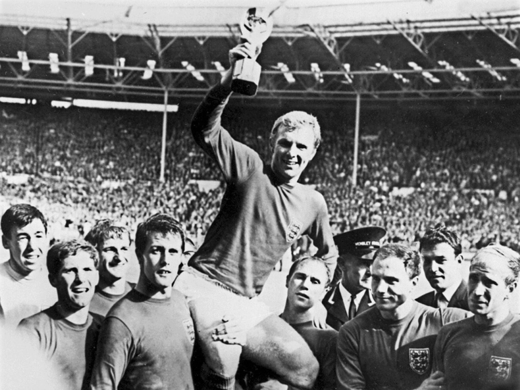 File picture of England's national soccer team captain Bobby Moore holding aloft the Jules Rimet trophy as he is carried by his teammates