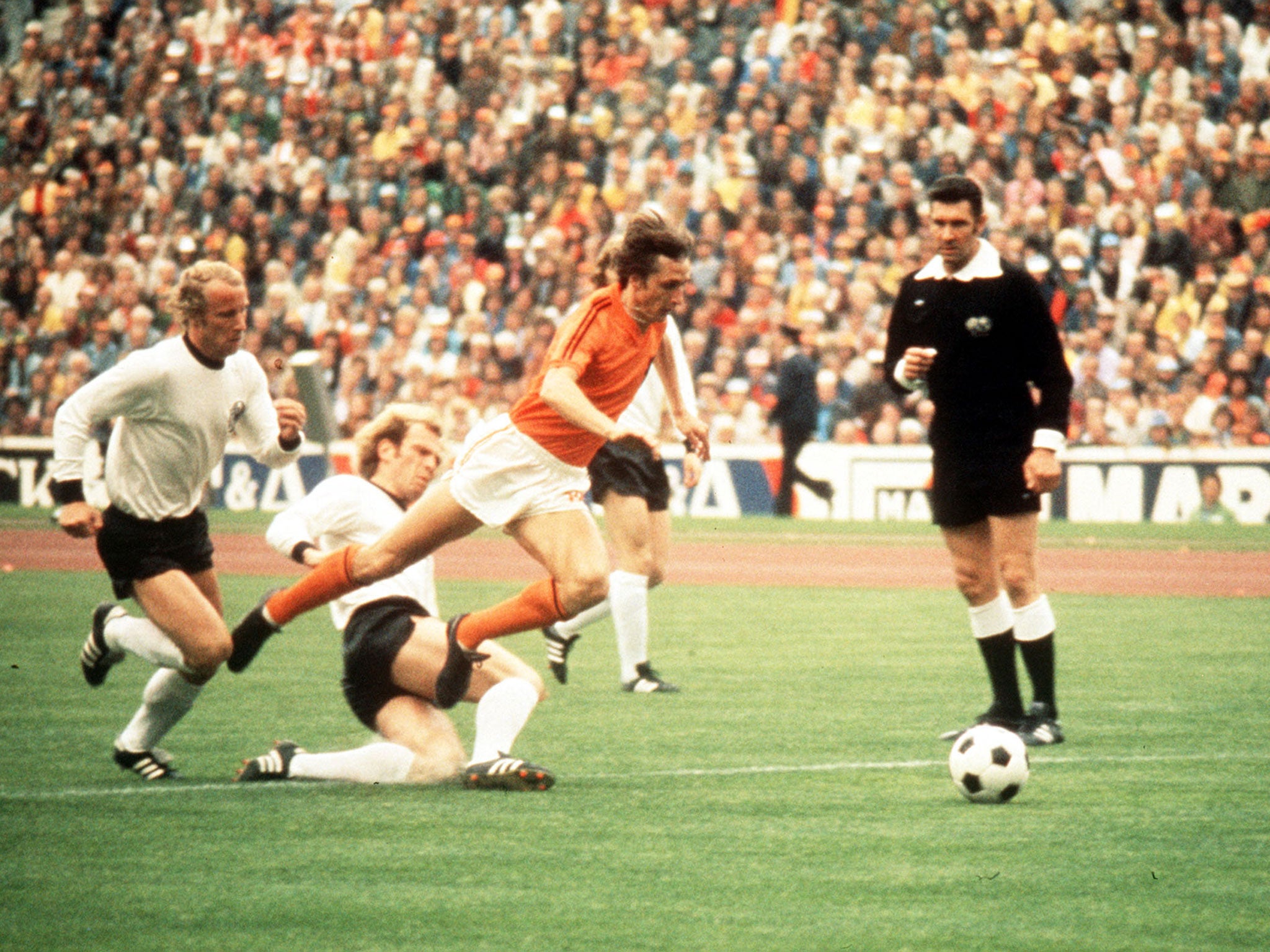Johan Cruyff of Holland jumps a tackle from Uli Hoeness of West Germany during the 1974 World Cup Final. Mandatory Credit: Allsport UK/ALLSPORT