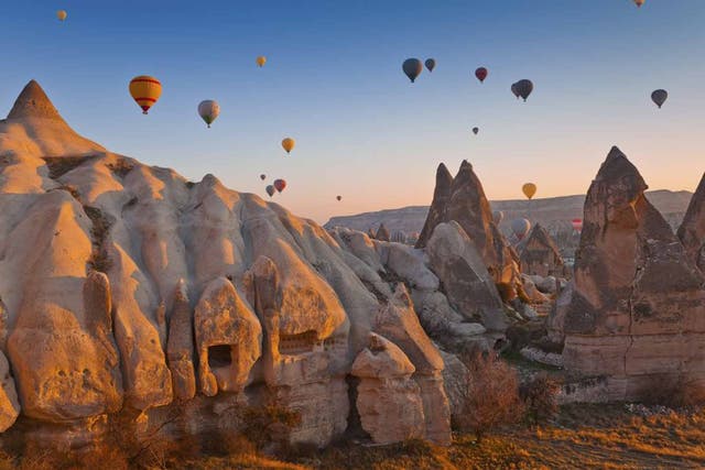 Tourism soars: hot air ballons over caves in Cappadocia