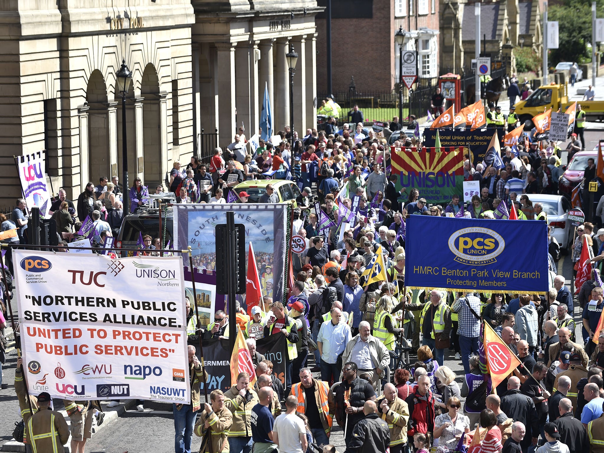 Public sector workers march through Newcastle city centre as they take part in the one-day walkout as part of bitter disputes over pay, pensions, jobs and spending cuts