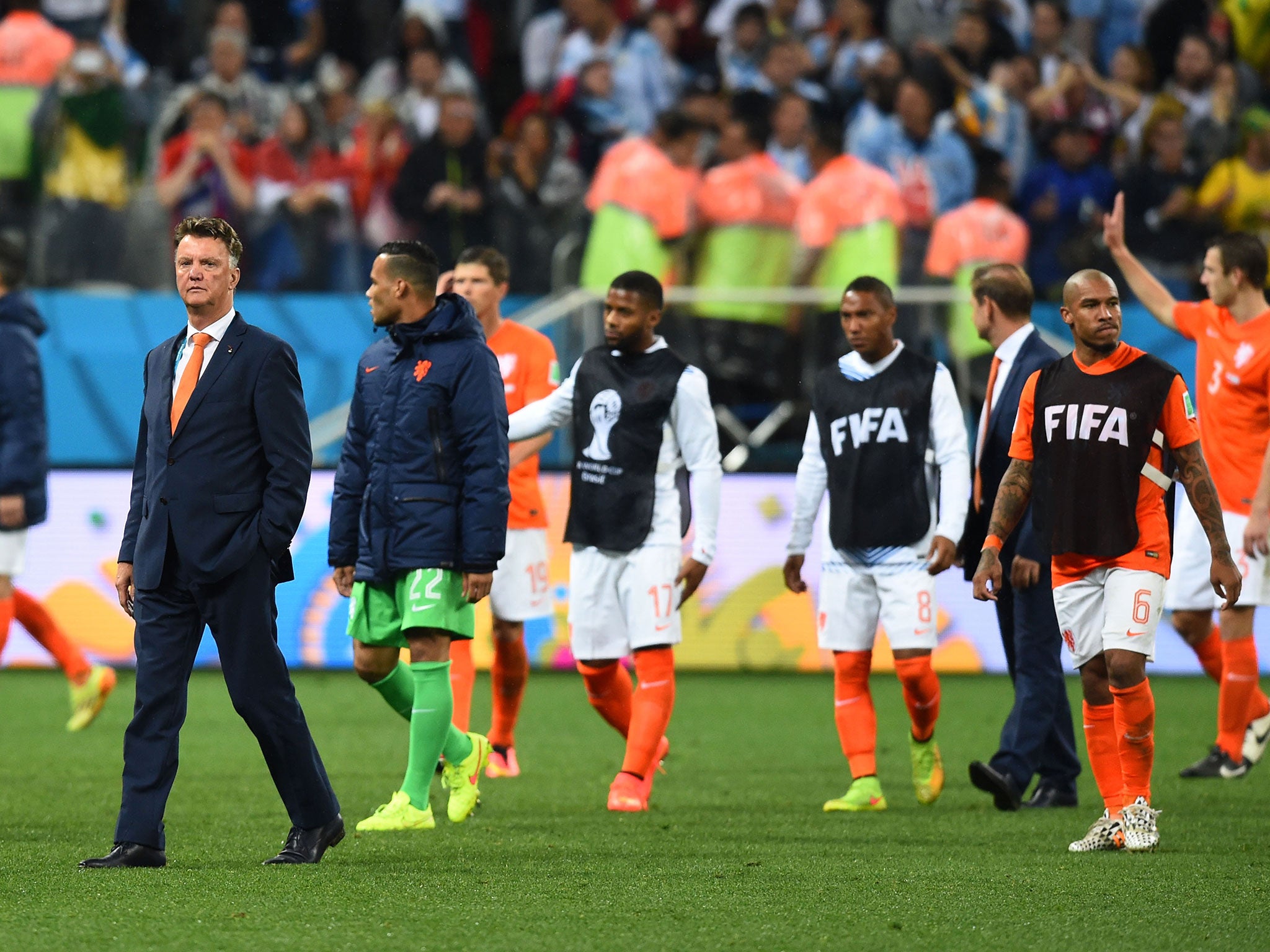 Head coach Louis van Gaal of the Netherlands looks on with his team after being defeated by Argentina in a penalty shootout during the 2014 FIFA World Cup Brazil Semi Finals