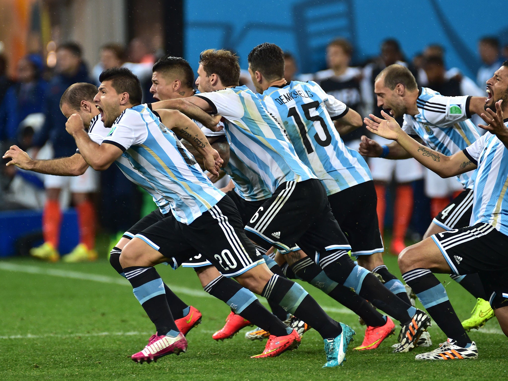 Argentina's players run to celebrate their victory after a penalty shoot out following extra-time in the semi-final football match between Netherlands and Argentina of the FIFA World Cup at The Corinthians Arena in Sao Paulo