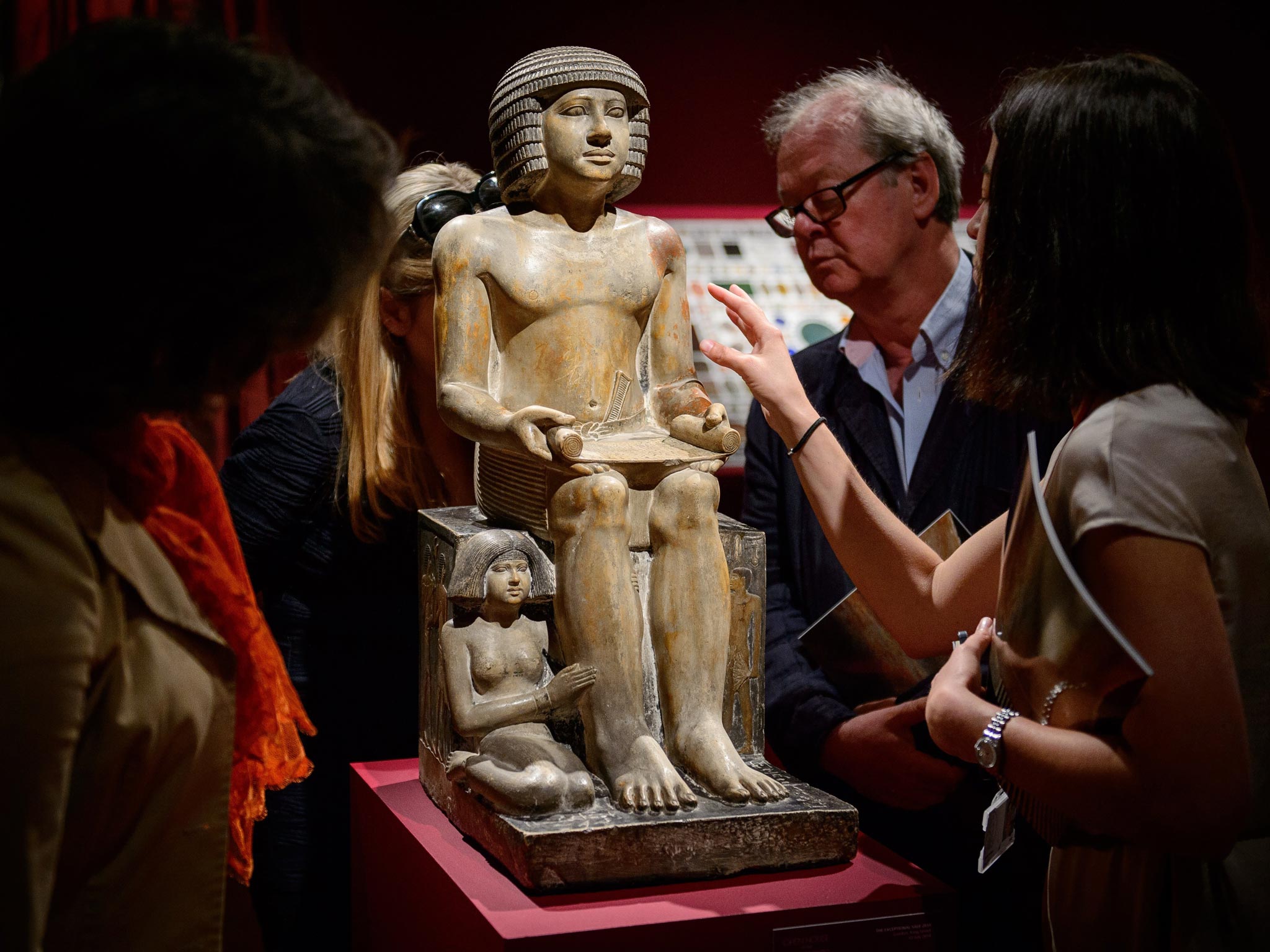Members of the public and gallery staff examine The Northampton Sekhemka, an Egyptian painted limestone statue of Sekhemka, Inspector of the Scribes