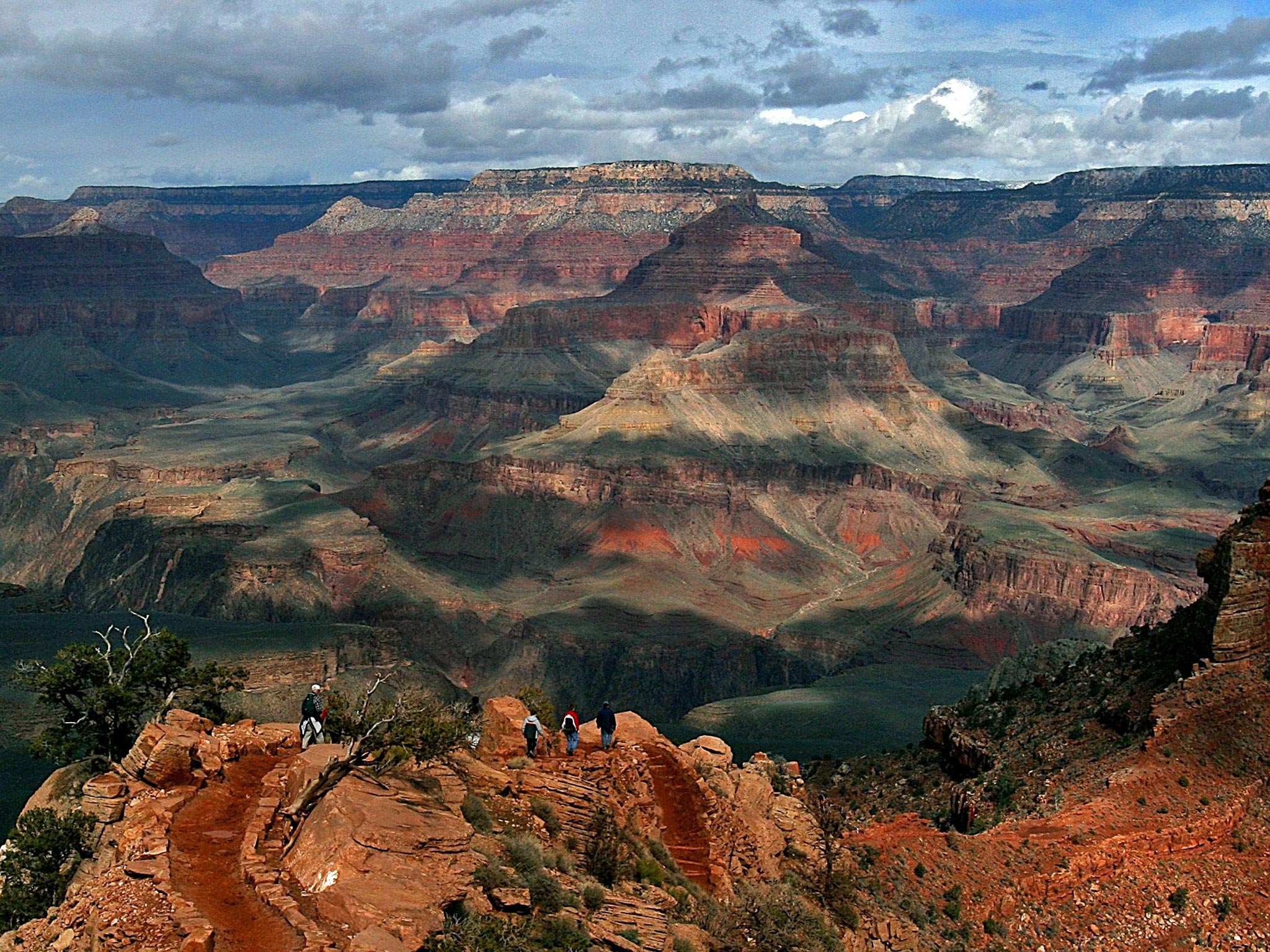 Tourists hike along the South Rim of the Grand Canyon in Arizona. Soon the view could include a 420-acre hotel, restaurant and retail complex, plus a cable-car gondola for visitors