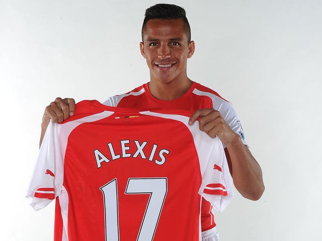 Alexis Sanchez poses with his new Arsenal shirt