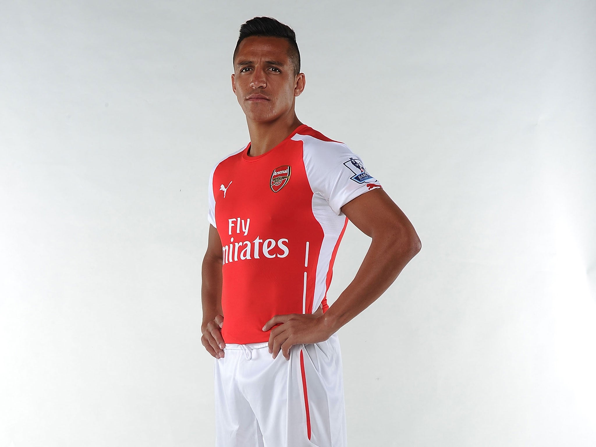 Alexis Sanchez poses during his Arsenal unveiling