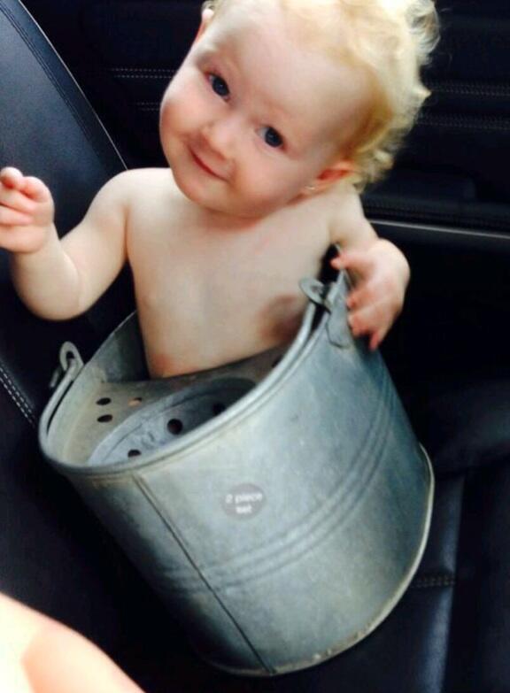 A toddler got stuck in a metal mop bucket