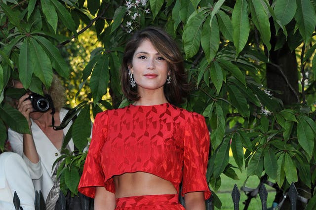 Red alert: From the neck up Arterton looks amazing, but this skirt should have been left to its duty as a lampshade