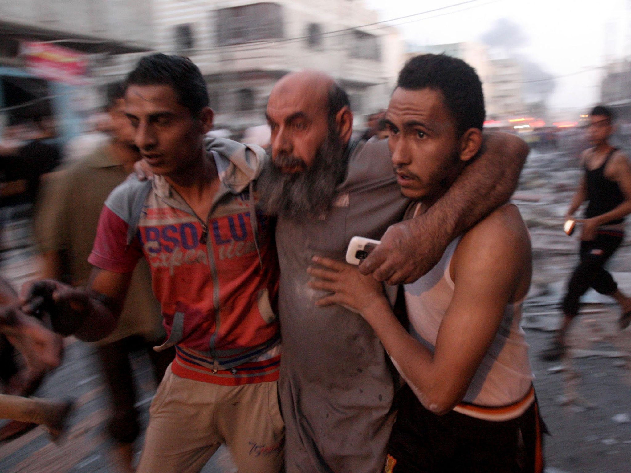 People run for safety during an Israeli air attack