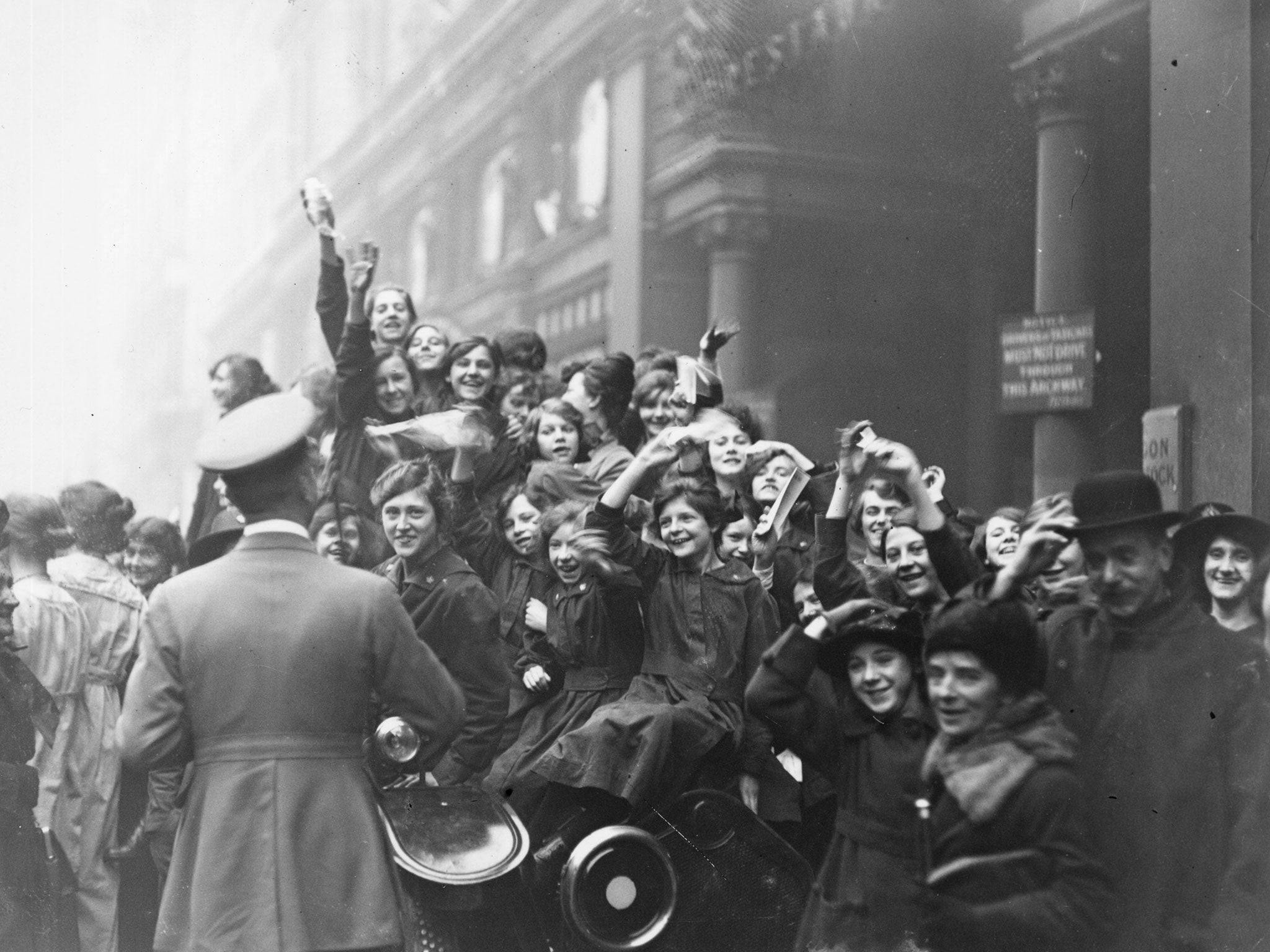 Crowds in London celebrate the end of hostilities on 11 November 1918