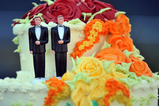 A wedding cake with statuettes of two men is seen during the demonstration