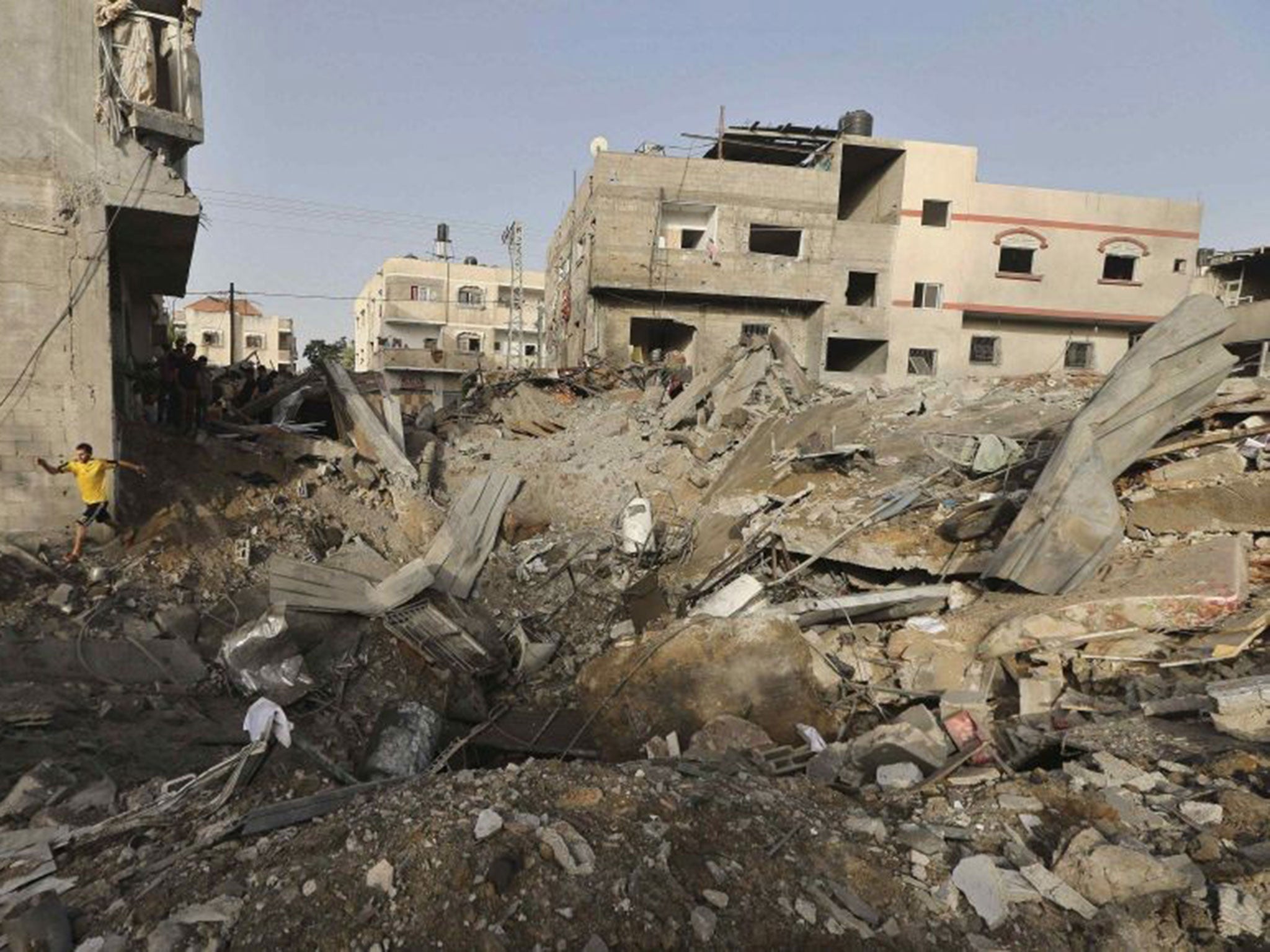 A Palestinian man walks amidst the rubble of a house which police said was destroyed in an Israeli air strike in the northern Gaza Strip July 12, 2014.