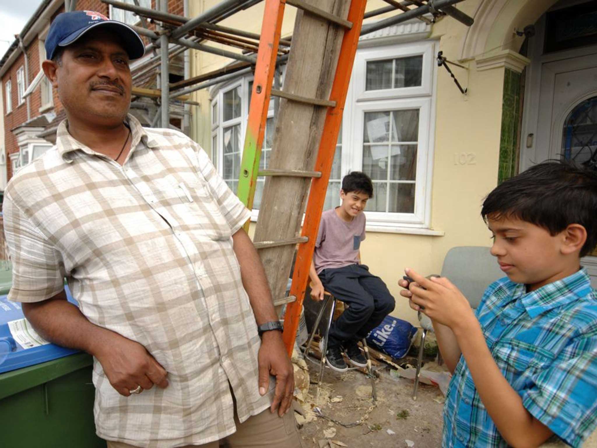 Resident Mushdaq Hussain with sons Faraz (pink top) and Azatar