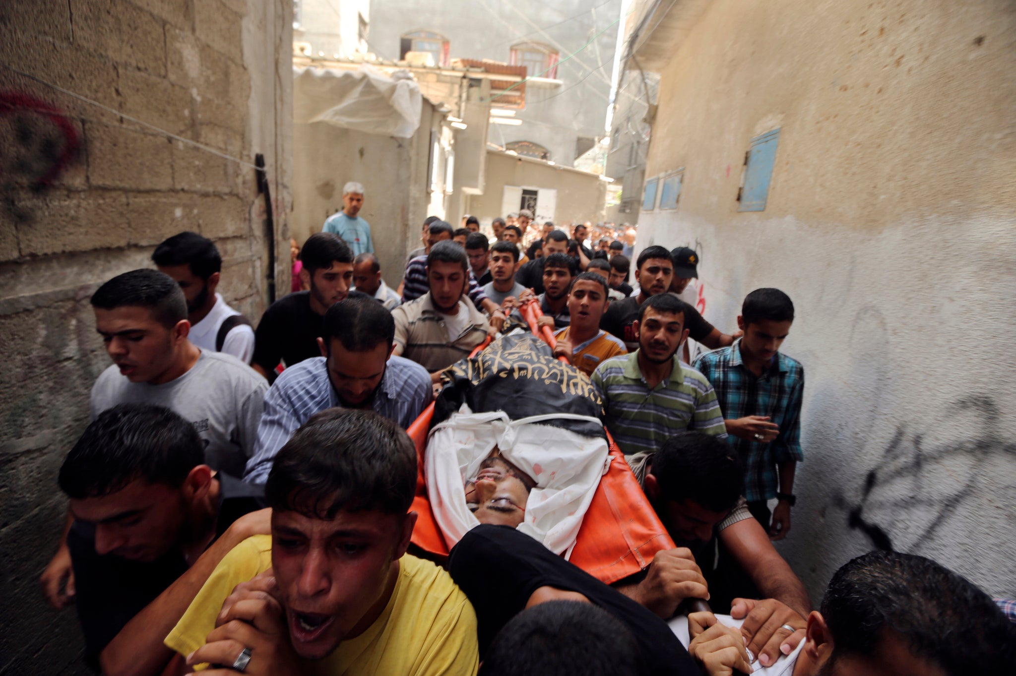 Mourners carry the body of a Palestinian militant
