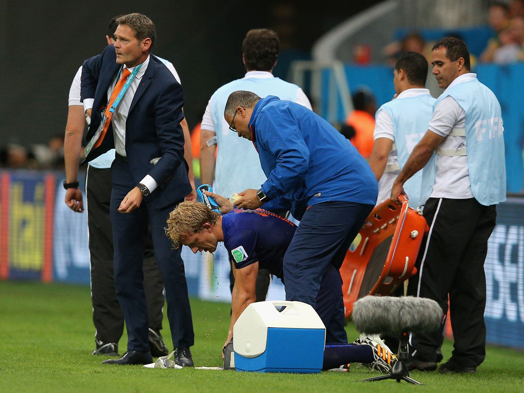 Dirk Kuyt of the Netherlands receives treatment after a clash