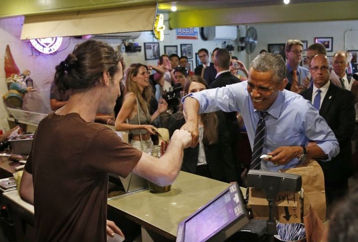 Obama fist bumps Webb after paying for his order at Franklin Barbecue in Austin, Texas