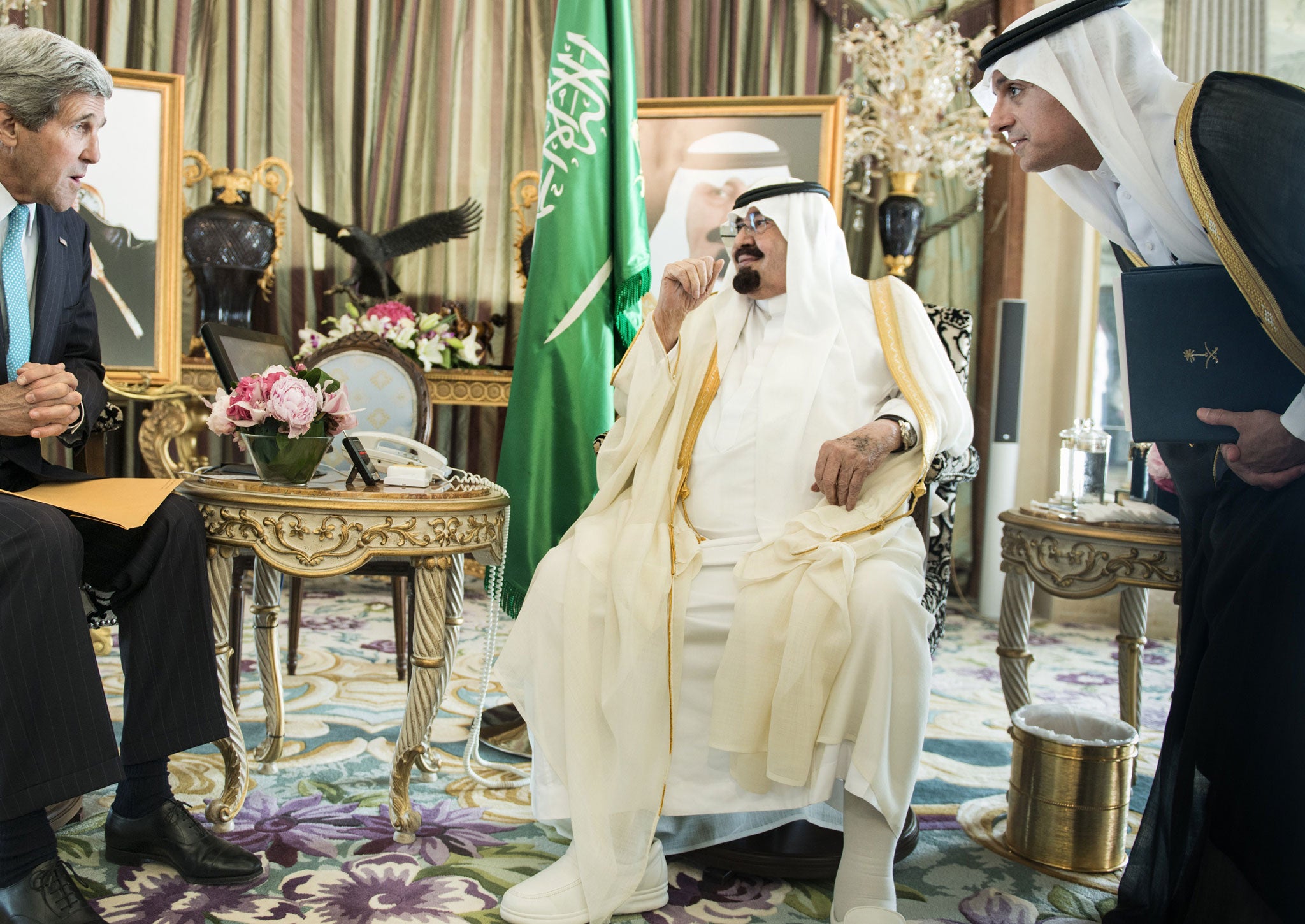 Saidi ambassador to the US Adel al-Jubeir (R) listens to US Secretary of State John Kerry (L) while interpreting for King Abdullah bin Abdulaziz Al-Saud before meeting at the King's private residence