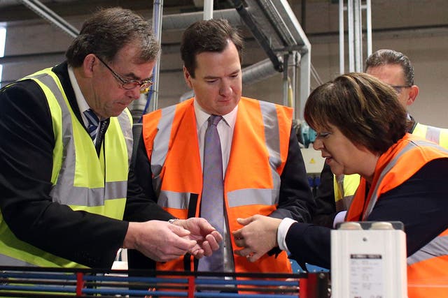 Chancellor George Osborne (C) wears a high visibility jacket as he makes a visit to the Prysmian Group factory and speaks to factory manager Steve Price