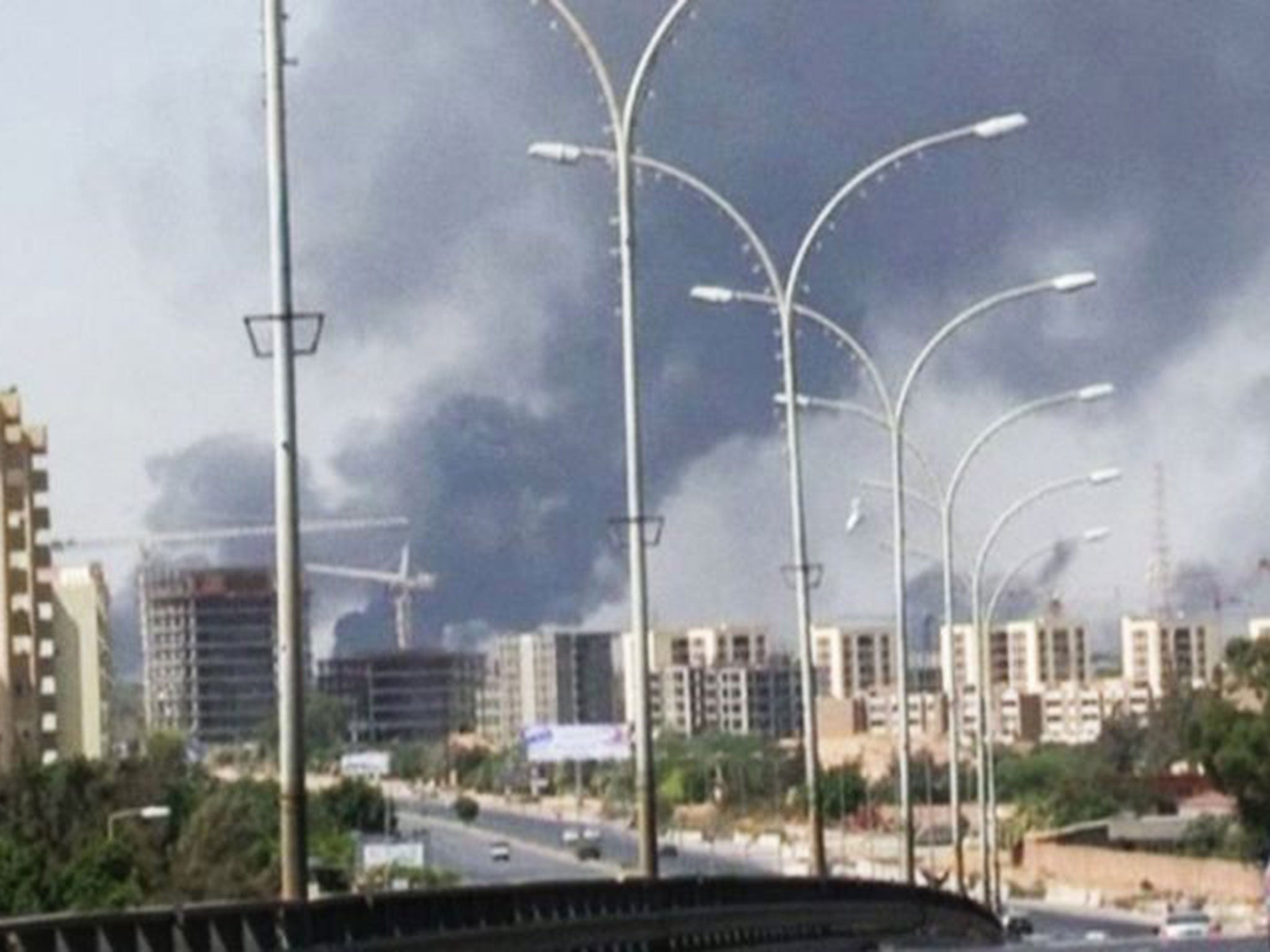 Smoke rises from the airport where rebel militias fight