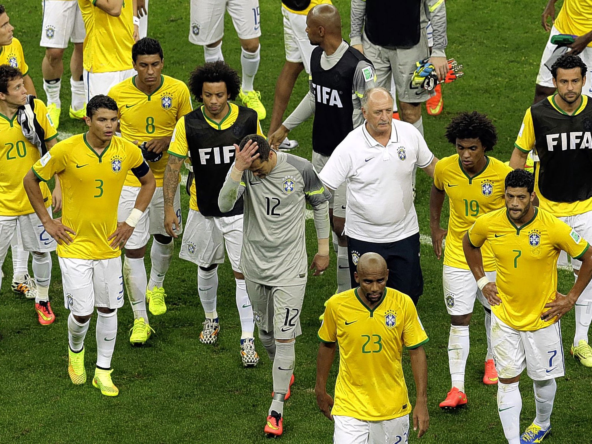 Luiz Felipe Scolari and his players leave the pitch after their 3-0 third-place play-off defeat to the Netherlands