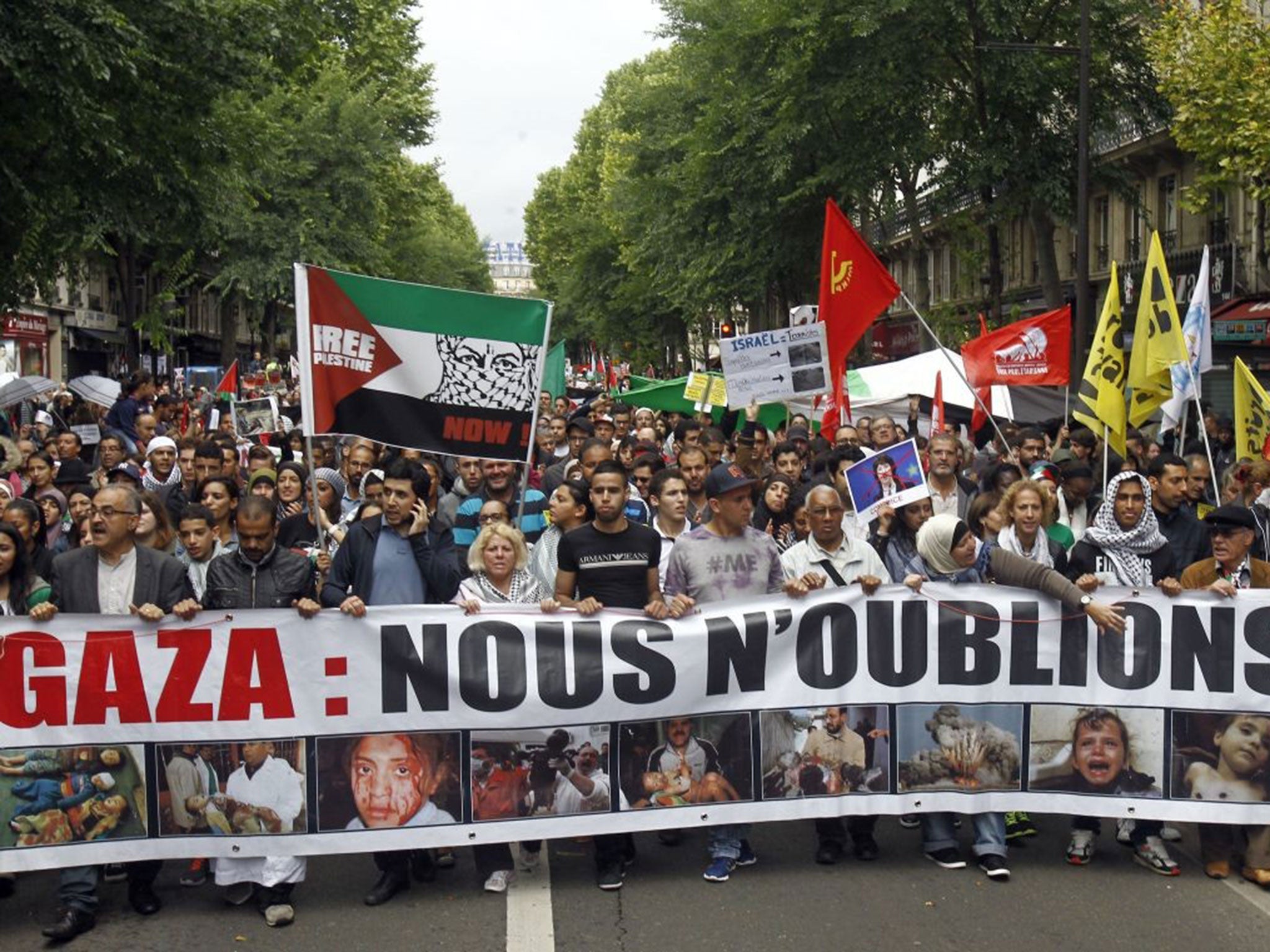 Thousands of pro-Palestinian demonstrators holding banners and chanting anti Israeli slogans walk in Paris, Sunday July 13, 