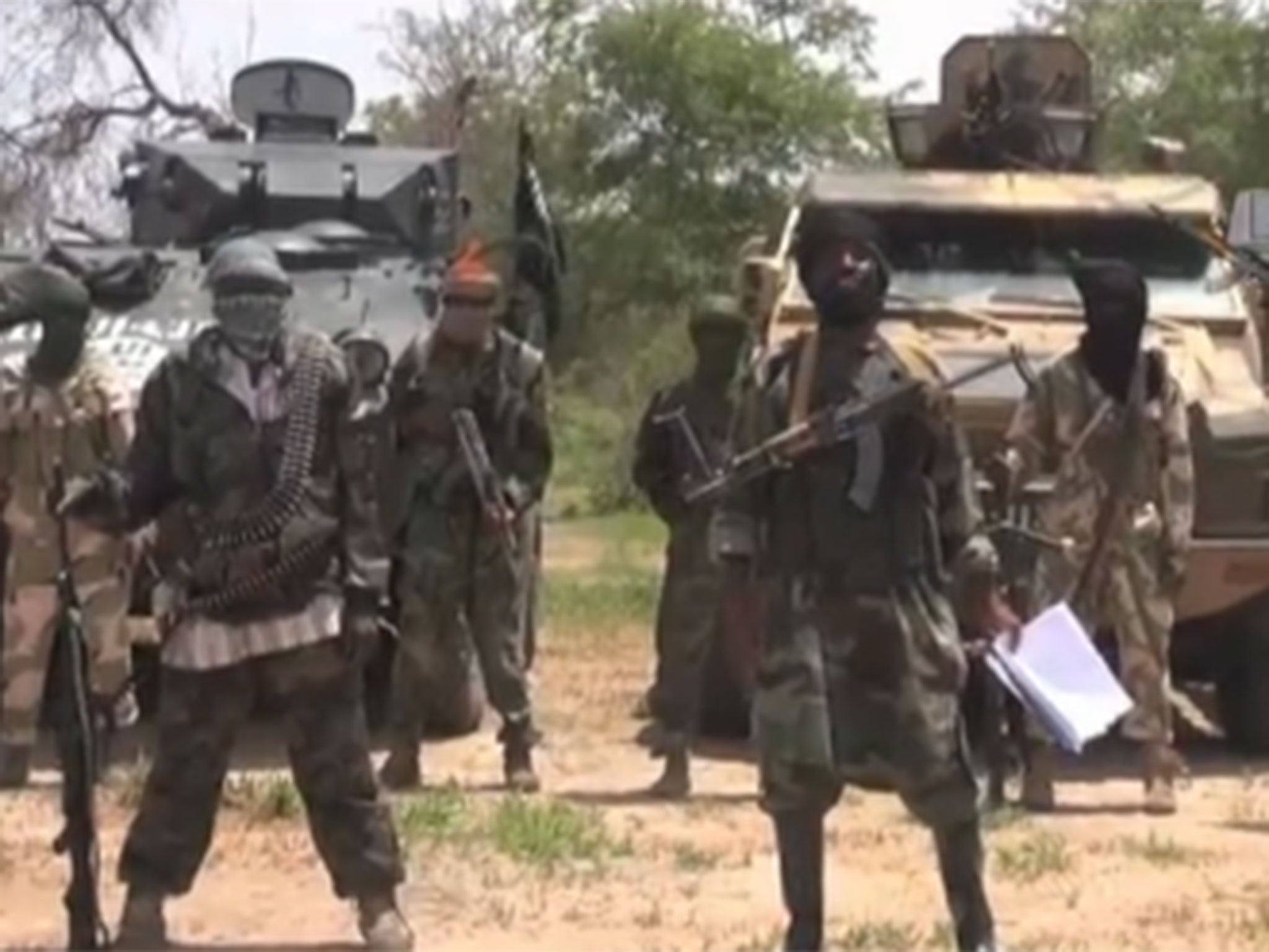 Boko Haram's leader Abubakar Shekau (R) delivers his message