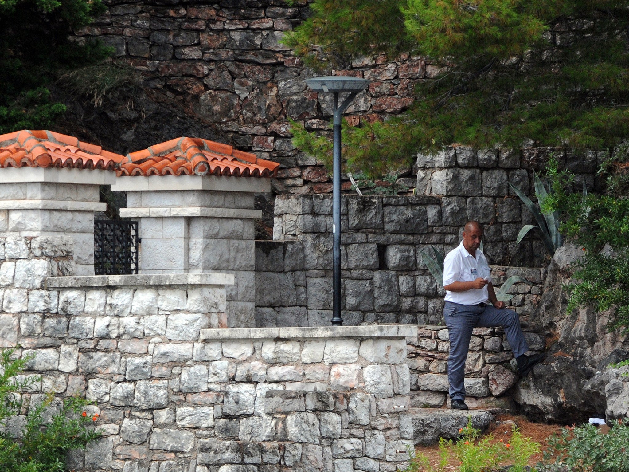 A security officer guards the entrance to the park where Novak Djokovic's wedding was held at the luxurious Adriatic resort of Sveti Stefan