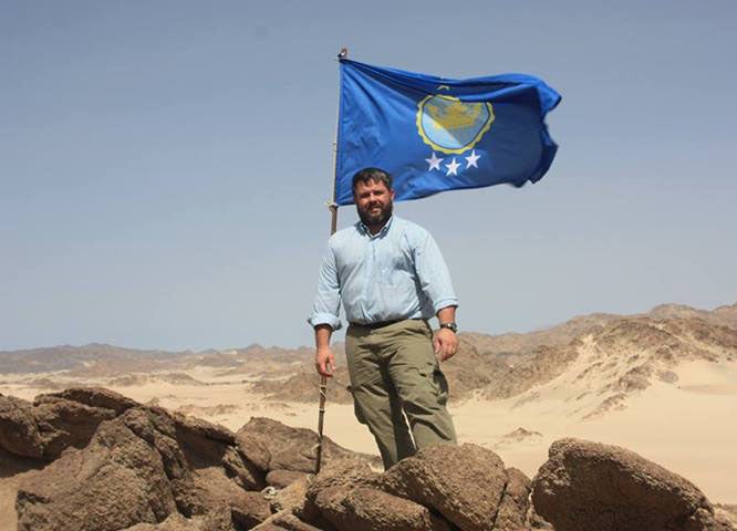 Jeramiah Heaton putting up a flag to make his daughter Princess of the Kingdom of North Sudan