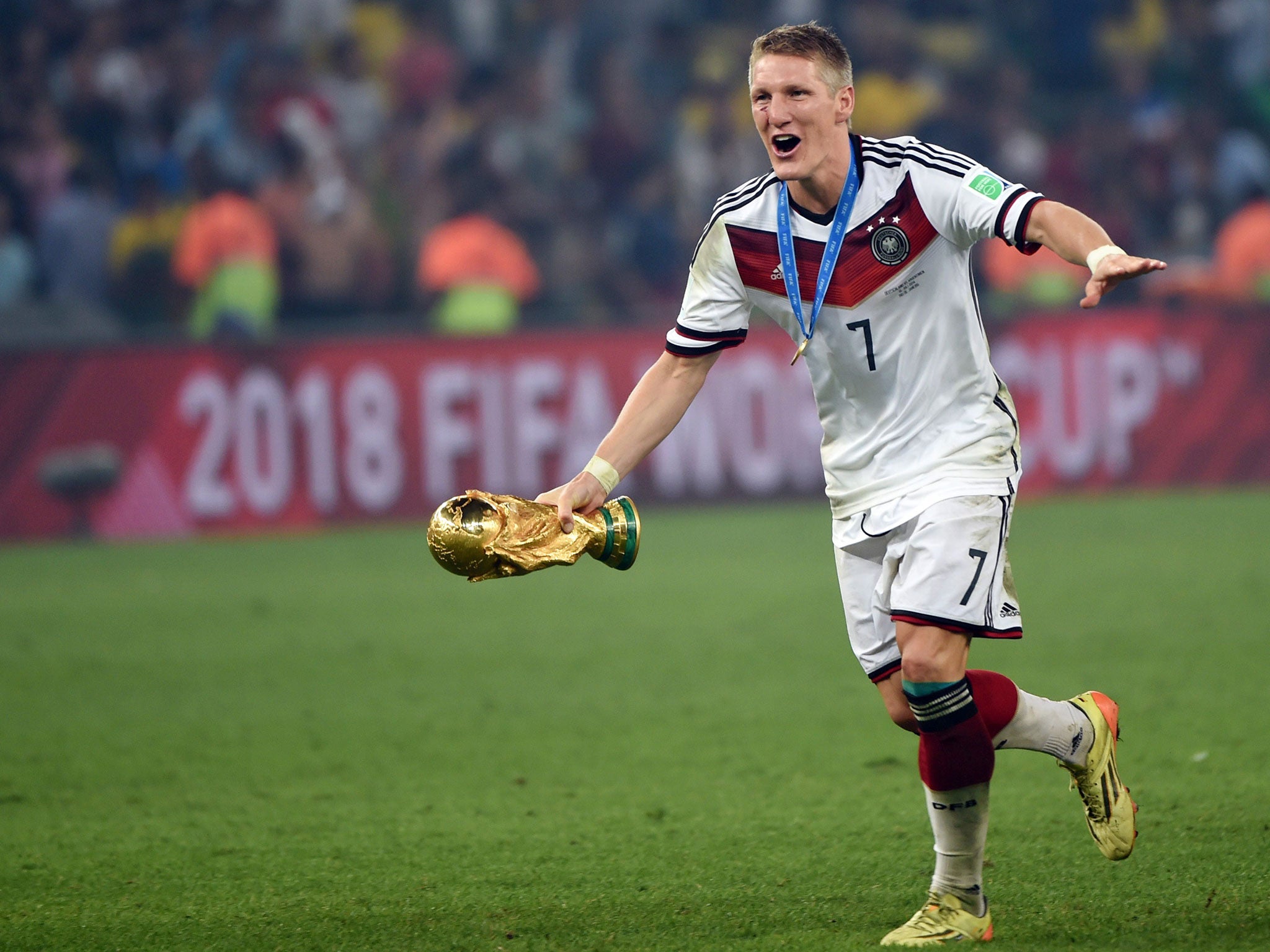 Bastian Schweinsteiger of Germany lifts the World Cup trophy with