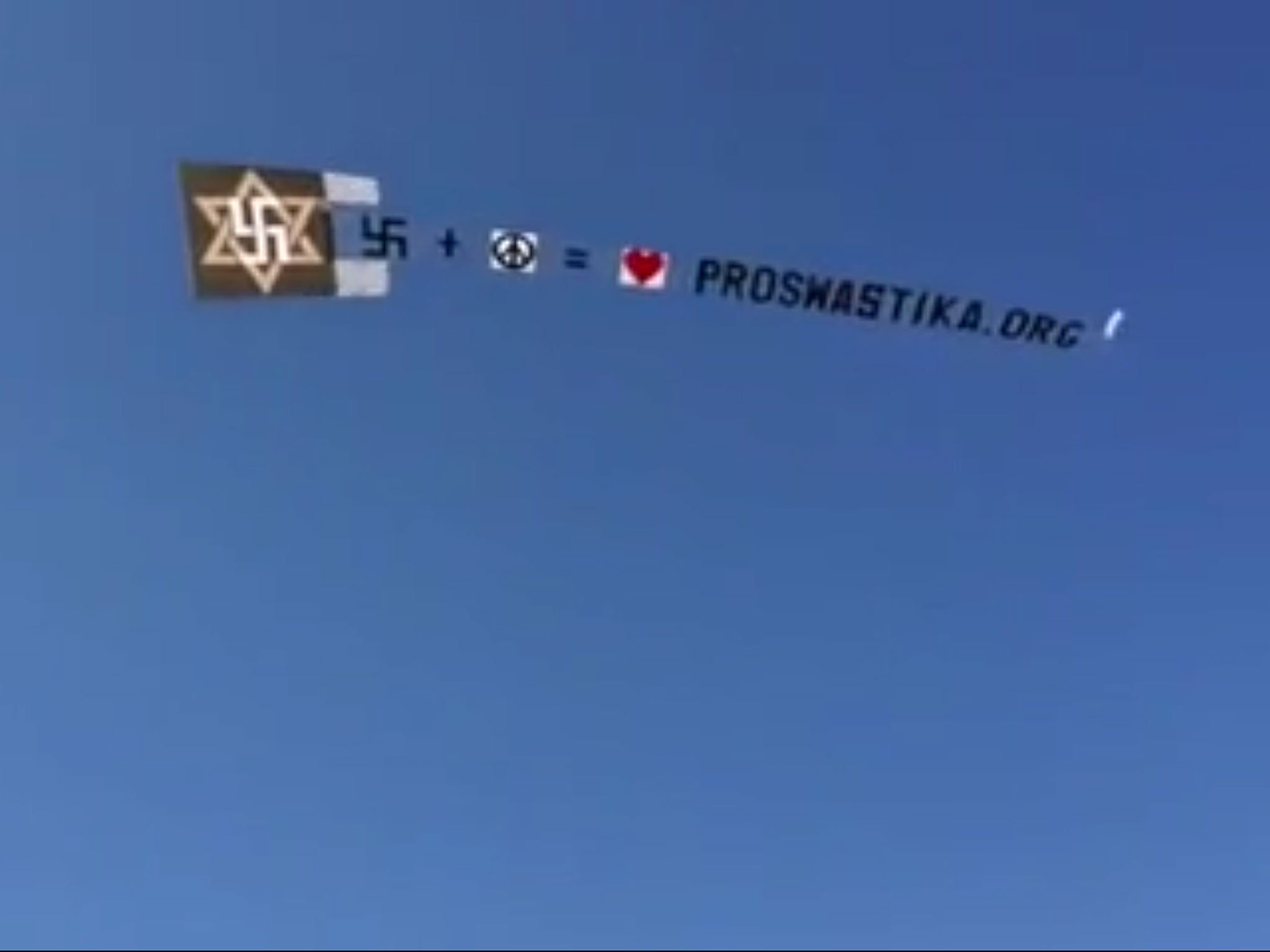 The International Raelian Movement flew the swastika symbol over Coney Island in southern Brooklyn in a bid to promote its original peaceful meaning. However, the religious group flew the banner over an area housing the largest remaining number of World W
