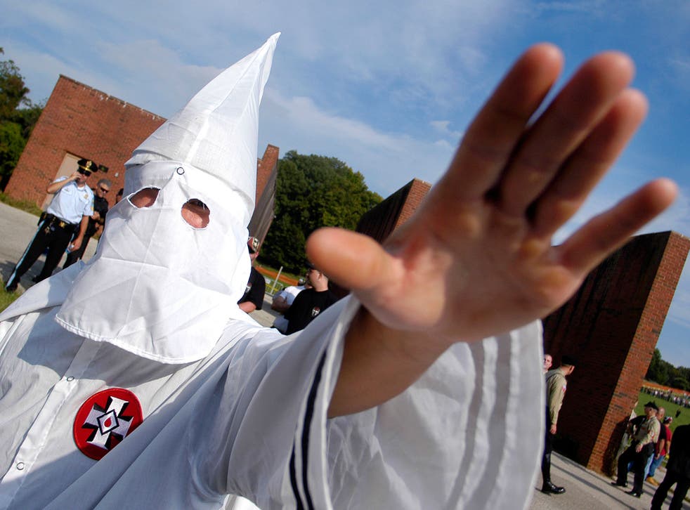  A member of the Ku Klux Klan salutes during an American Nazi Party rally at Valley Forge National Park September 25, 2004, in Valley Forge, Pennsylvania