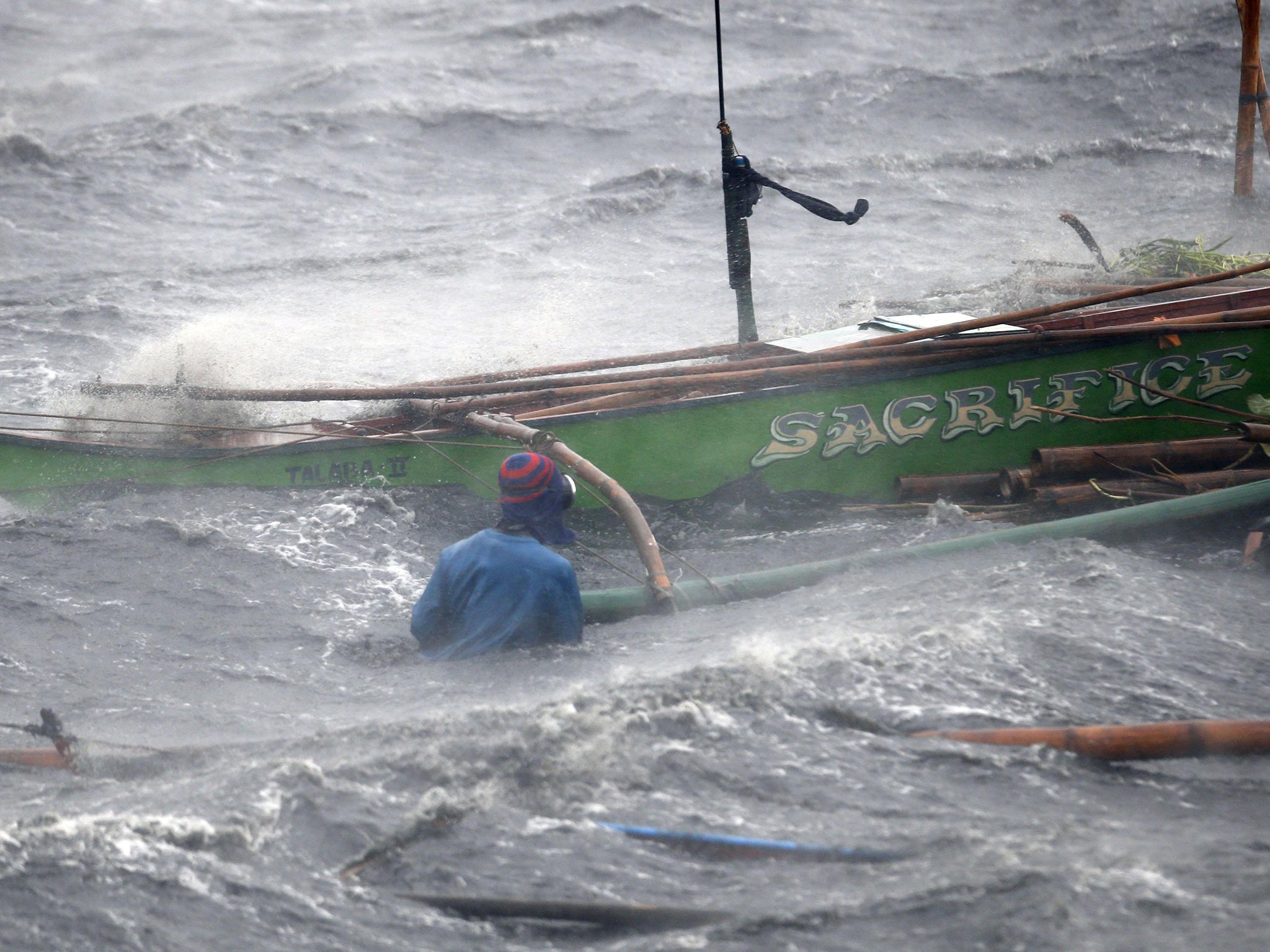 A fisherman secures his boat as Typhoon Rammasun hits the coastal town of Imus, Cavite southwest of Manila. Philippine authorities evacuated almost 150,000 people from their homes and shuttered financial markets, government offices, businesses and schools