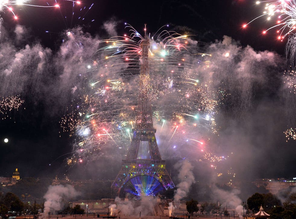 Fireworks burst around the Eiffel Tower in Paris as part of France's annual Bastille Day celebrations 