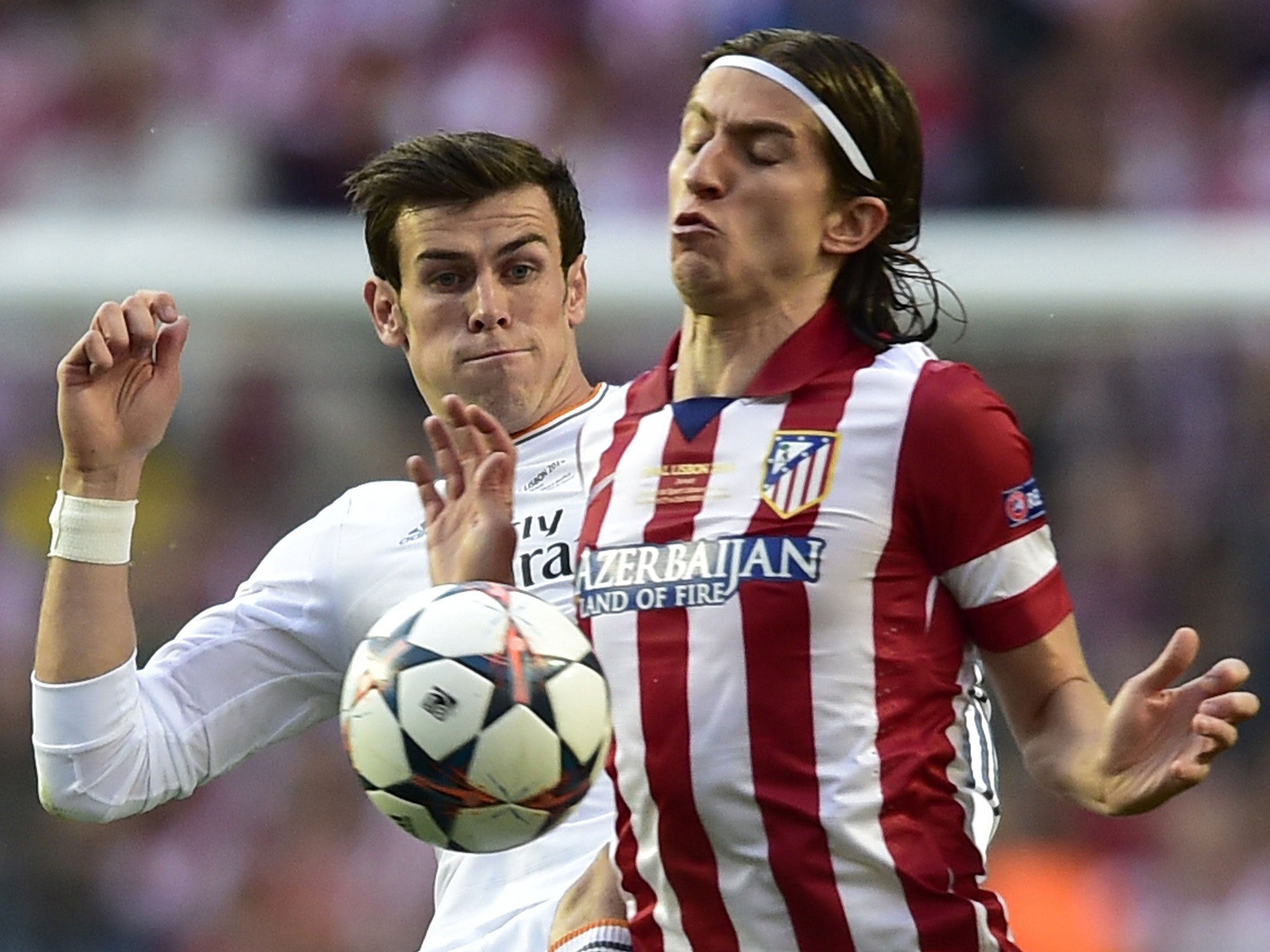 Filipe Luis competes for the ball with Gareth Bale