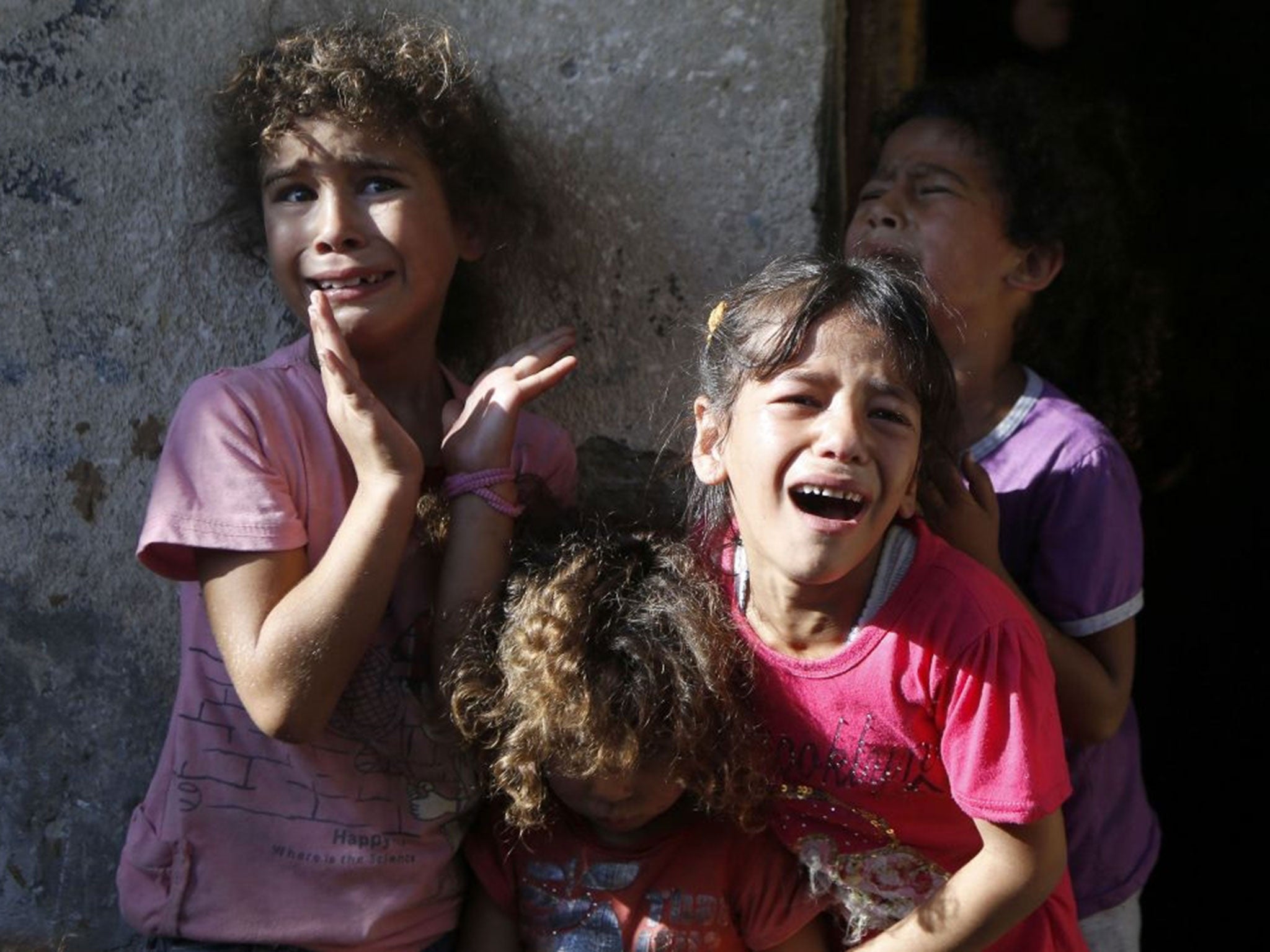 Young relatives of four boys, all from the Bakr family, killed during Israeli shelling, cry during their funeral in Gaza City