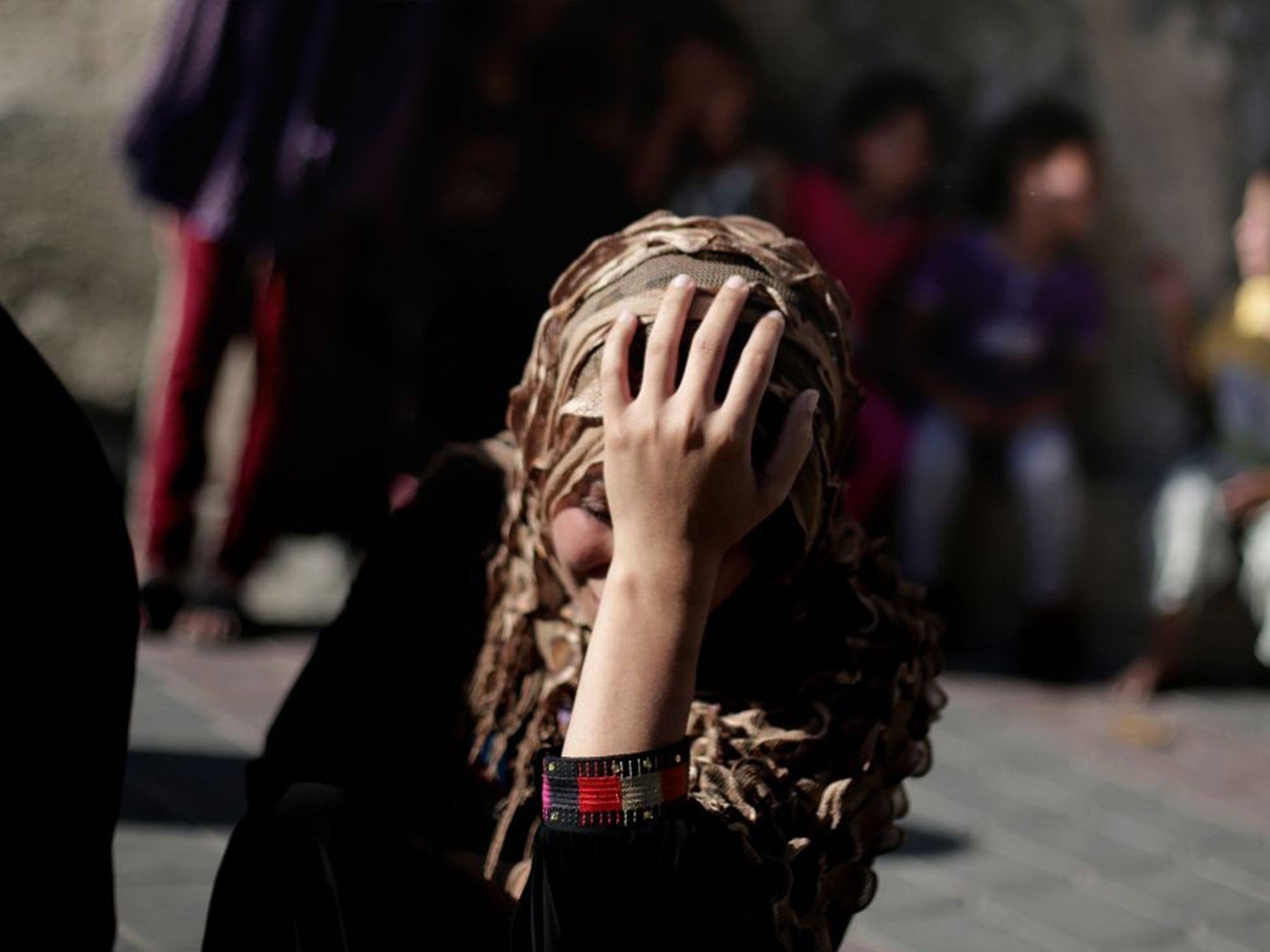 Palestinian relatives of four boys from the same family mourn during their funeral in Gaza City