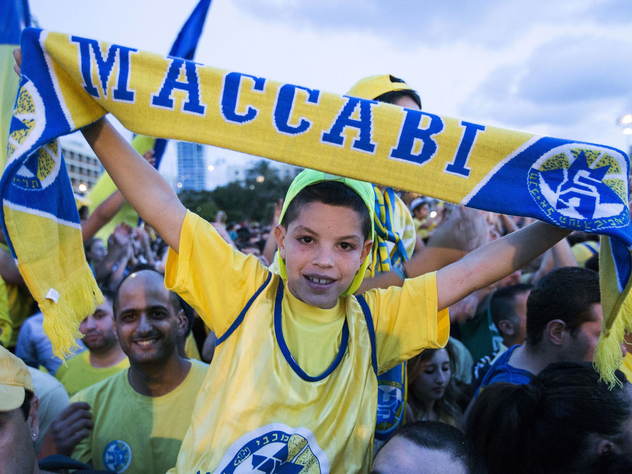 Maccabi Tel Aviv fans celebrate their team's win in Kikar Rabin or Rabin Square in Tel Aviv, on May 19, 2014, following last night's victory over Real Madrid in the Euroleague 2014