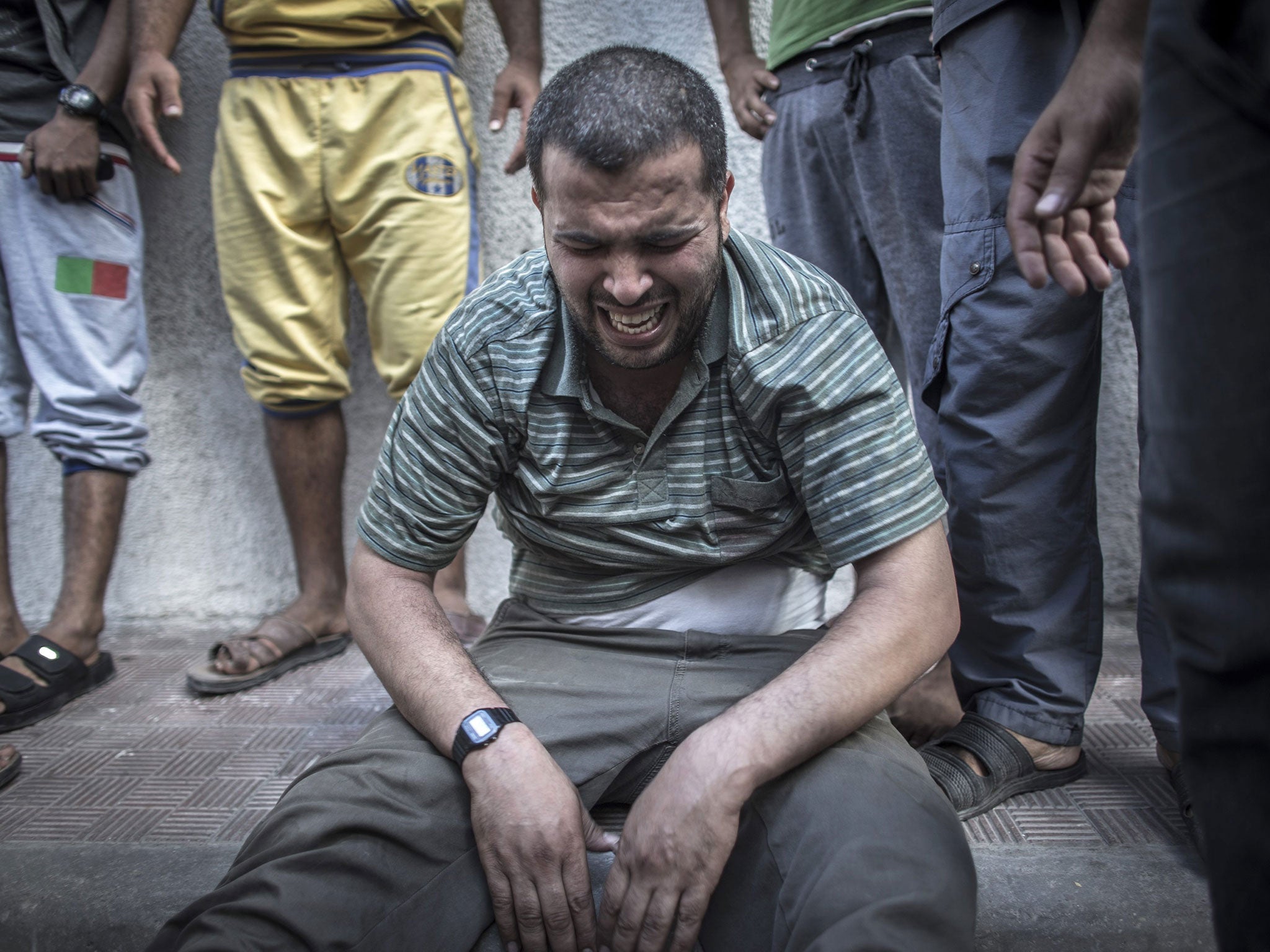 A Palestinian man is left distraught after losing relatives in an air strike