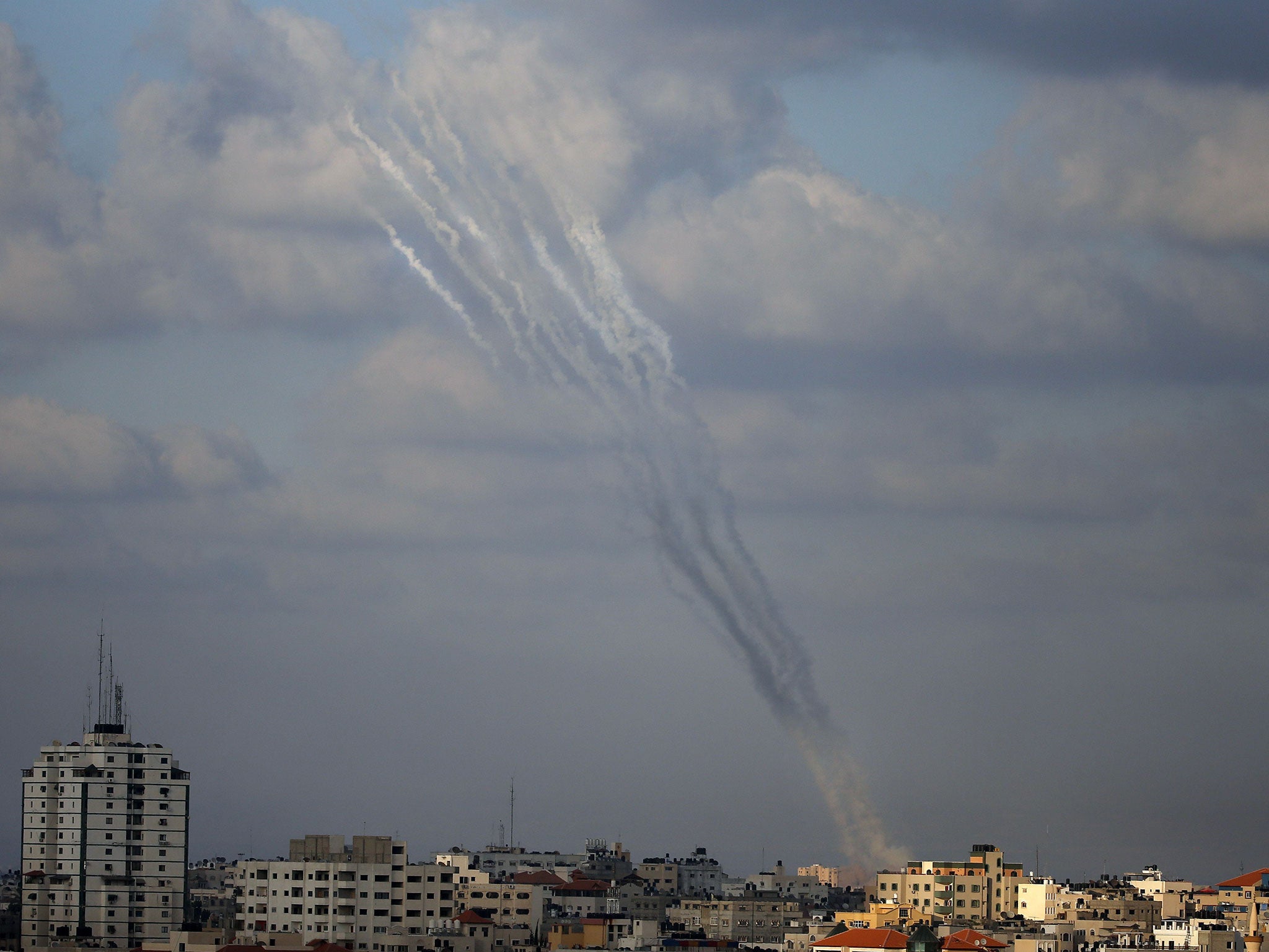Smoke from rockets fired from a northern neighborhood of Gaza City are seen after being launched toward Israel