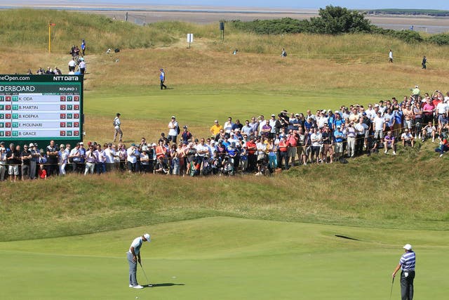 Tiger Woods lines up a putt at Royal Liverpool yesterday