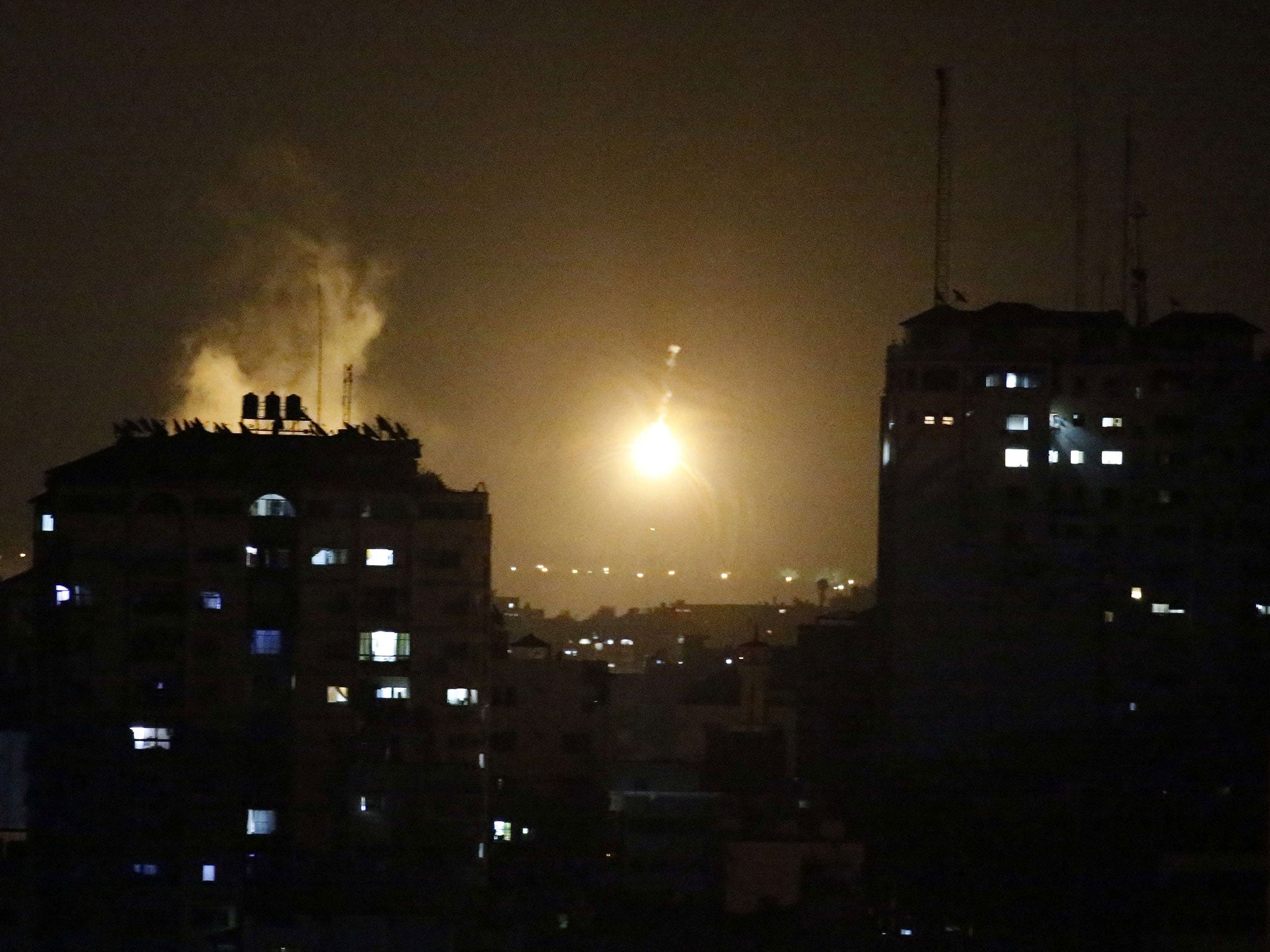 An Israeli missile hits Palestinian buildings in Gaza City