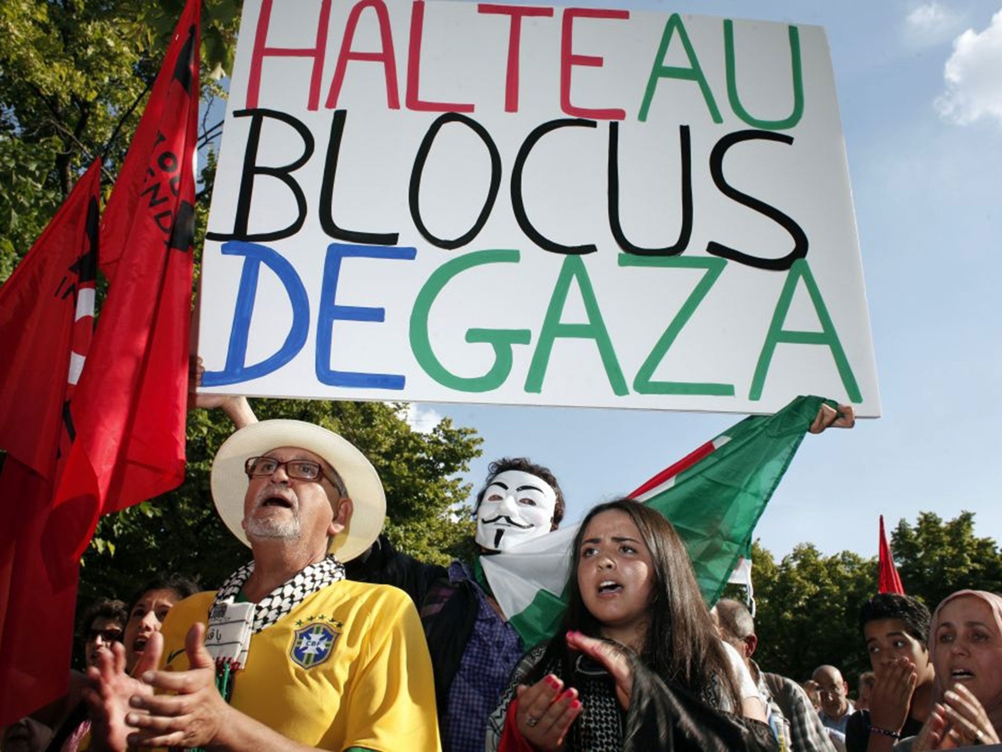 Pro-Palestinian demonstrators shout anti Israeli slogans during a protest against the Israeli army's bombings in the Gaza strip, in Paris, Wednesday, July 16, 2014. Placard reads: "Stop the blockade of Gaza".