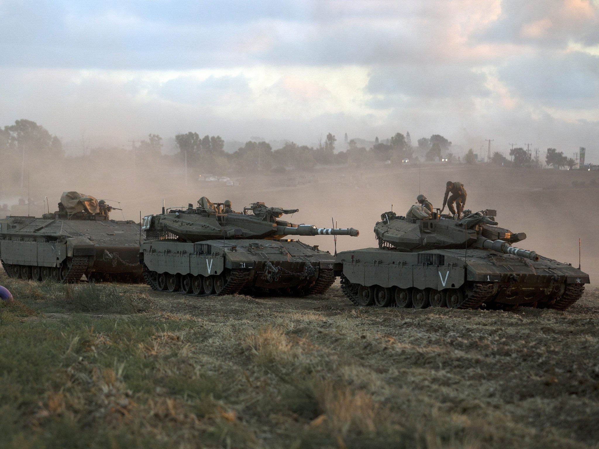 An Israeli armoured column moves towards the Gaza border yesterday