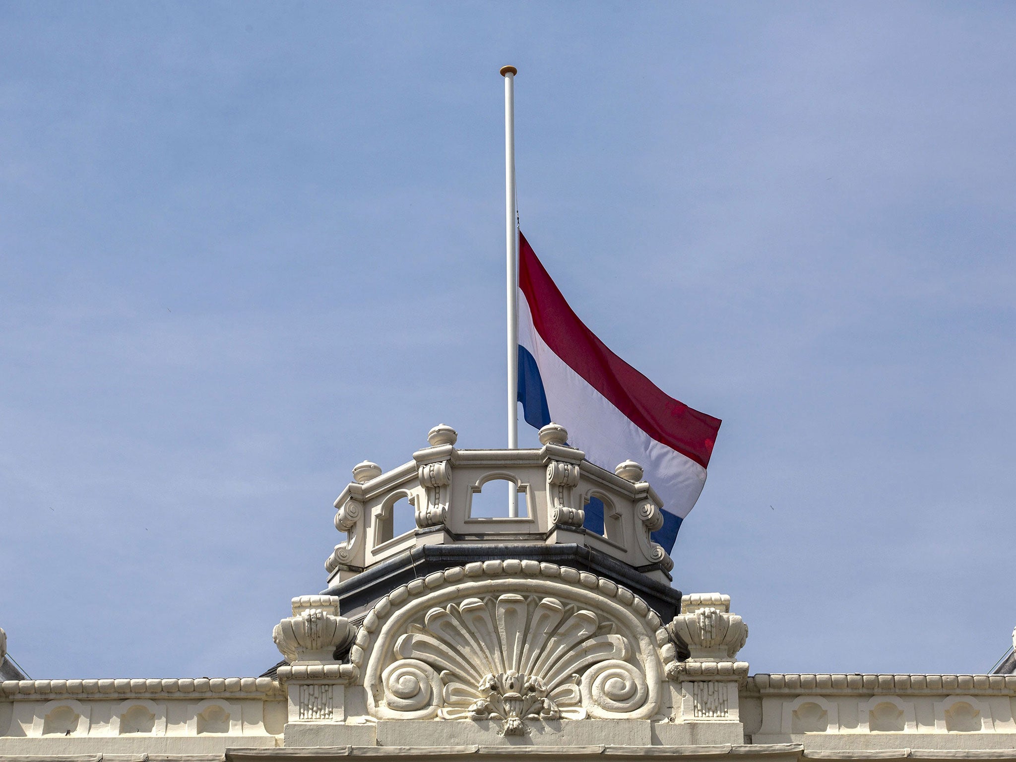 The Dutch flag flies at half-staff at the Kneuterdijk Palace in The Hague